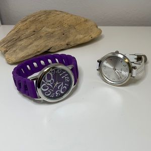 Two watches. One is purple and the other white.